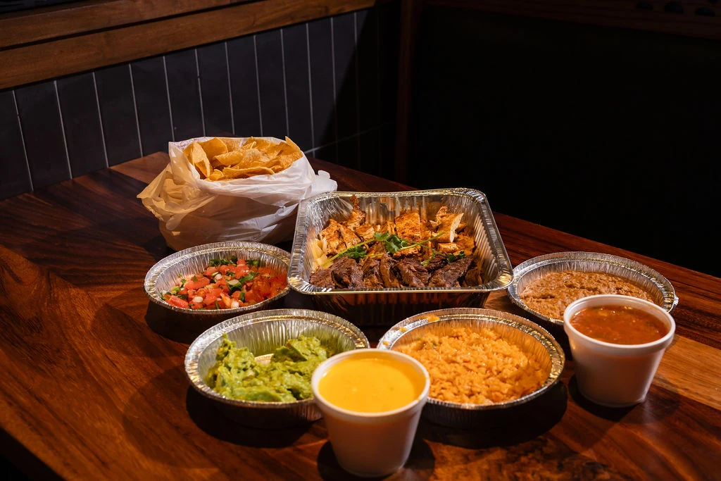 Mi Rancho takeout fajitas and a spread of sides